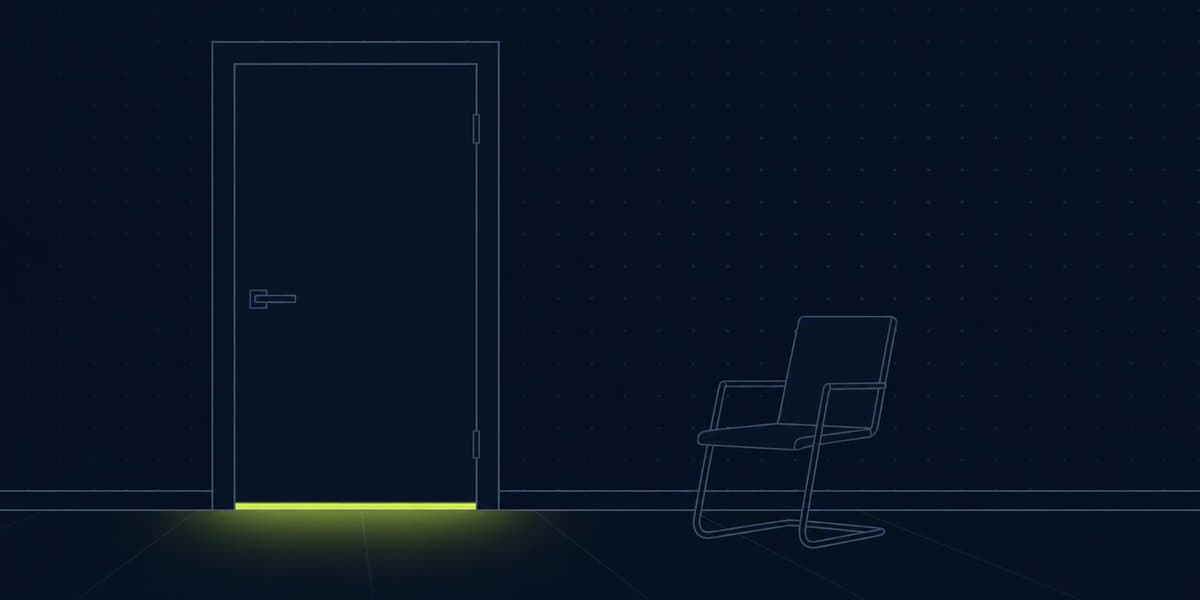A closed meeting room door with light underneath and an empty chair outside
